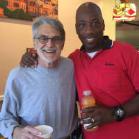 <p>Greg Pappas takes a break from the kitchen to pose with Scott, a Verizon employee on his lunch break</p>