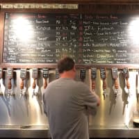 <p>A bartender at Growler &amp; Gill draws some liquid gold from one of the Nanuet gastropub&#x27;s 24 taps.</p>
