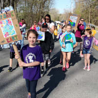 <p>Hawthorne Elementary student Jillian Lyden carrying a &quot;Save the Earth&quot; sign.</p>