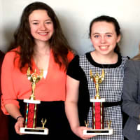 <p>Members of the Harrison High School Debate Team display their trophies.</p>