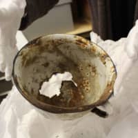<p>The museum&#x27;s Director of Education Amy SaNogueira holds a bowl from a concentration camp used for daily meals.</p>