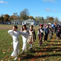 <p>Cottage Lane Elementary staff and students parade in costume on Halloween.</p>