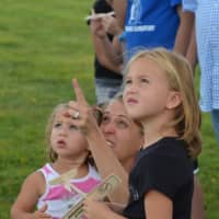 <p>Children watch the action last year as they clutch balsa wood gliders.</p>