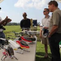 <p>Model aircraft enthusiasts look over miniature helicopters at the aerodrome last year in Haverstraw.</p>
