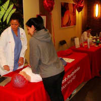 <p>Eva Santiago, RN, Cardiac Catheterization Lab, demonstrates hands-only CPR to Ritz Palazzo of Yonkers.</p>