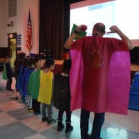 <p>Colorfully caped students and staff at Daniel Warren Elementary School in Rye Neck march in capes during an assembly Dec. 10 to celebrate their own strengths.</p>