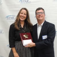 <p>Hitachi Capital Vice President Jim Giamo accepts Community Service Award on behalf of Hitachi Volunteers from Megan Johnson of STAR.</p>