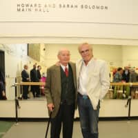 <p>Howard Solomon and Peter Martens pose in front of the Howard and Sarah Solomon Main Hall at Lincoln Center.</p>