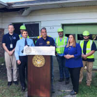 <p>Officials gather in a Long Island community to demolish a zombie home.</p>