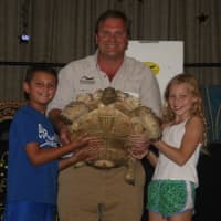 <p>Animal Embassy&#x27;s Chris Evers shows students a huge tortoise during his visit to Royle Elementary School.</p>
