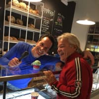 <p>Owner Mike Pietrunti passes a dish of pistachio to a customer at Uncle Louie G, a new ice cream franchise in Trumbull.</p>