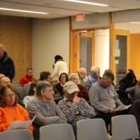 <p>The audience fills in the Main Program Room at Ridgefield Library and reviews handouts prior to a talk on Hiking in Fairfield County by Jeff Glans.</p>