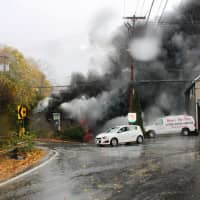 <p>The auto body shop became engulfed in flames shortly after 1:30 p.m. Tuesday.</p>