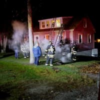 <p>Firefighters ladder the building to check the exterior and roof of the house.</p>