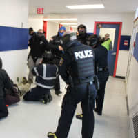 <p>Police departments from multiple towns, along with EMS, practice an active-shooter drill at the shuttered Lewisboro Elementary School.</p>
