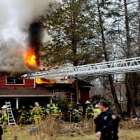 <p>Mohegan uses the ladder pipe to douse the fire upstairs.</p>