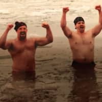 <p>Participants in an annual Super Bowl Sunday fundraising plunge celebrate at Grassy Point.</p>