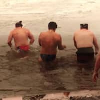 <p>Andy Huber with John Corcoran (in black knit cap), Chris Bryceland in a doo rag and John Fox in back dark shorts during one of the annual Super Bowl Sunday plunges into the Hudson River at Grassy Point.</p>
