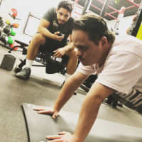 <p>Alex Rivera holds a plank with trainer JC Merino at Retro Fitness of Hackensack. The pair work together twice weekly, running through strength and cardio circuits that Alex say help him become a stronger fighter as a karate black belt.</p>