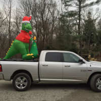 <p>It&#x27;s a Lewisboro tradition for Santa to leave a little &quot;present&quot; on the lawns of neighbors and friends at Christmastime. Here, DinoClaus arrives at his new holiday home in South Salem.</p>