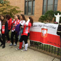 <p>Members of the Garfield High School Polish Club line up to watch the annual Pulaski Day Parade in Garfield Sunday morning, Oct. 4. </p>