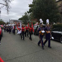 <p>The band and flag twirlers march to the beat at the annual Pulaski Day Parade in Garfield Sunday morning, Oct. 4. </p>