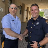 <p>Raneli with Capt. Frank Aquila, who said the officer went &quot;above and beyond.&quot;</p>