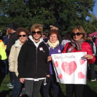 <p>Coldwell Banker employees show a sign they made for Sunday&#x27;s walk. </p>