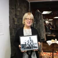 <p>Susan McCaslin shows a photograph of the Leatherman, a man who lived in the region in the 19th century. Works in her new art exhibit at CAWC in Danbury are inspired by the stories of the Leatherman.</p>