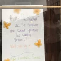 <p>A sign is posted in the doorway of Fish Urban Dining in Ridgewood.</p>
