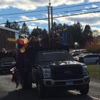 <p>Members of the Bethel Marching Band ride in a truck with the trophy it won earlier this month after taking first place at the U.S. Band championships in Allentown, Pa.</p>