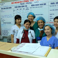 <p>Jennifer Padolina with another volunteer and some nurses.</p>
