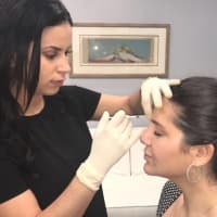 <p>Veronica Oliveros injects botox into a client at The Kaplan Center in Edgewater.</p>