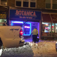 <p>A Hackensack worker clears the path outside of Botanica Thursday evening.</p>