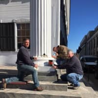 <p>Putnam Highway Department workers repair a pillar that is part of the historic Putnam County courthouse, which is more than 200 years old.</p>