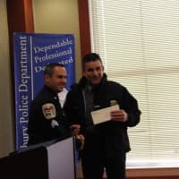 <p>Sg. James Antonelli of Danbury Police Department congratulates Chief James Viadero of the Newtown Police Department on receiving a donation for their K-9 program from the Gleszer estate.</p>