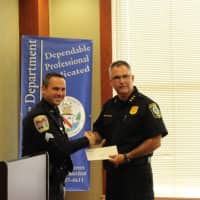 <p>Stratford Police Chief Joseph McNeil accepts his department&#x27;s share of the Gleszer bequest from Danbury Sgt. James Antonelli during a ceremony at Danbury Police Department Wednesday.</p>