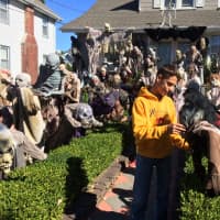 <p>Phillip Rodrigues, 16, takes a stroll through the cast of characters in front of his Lafayette Avenue home in Hawthorne Sunday, Oct. 11. </p>