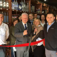 <p>First Selectman Mike Tetreau, center, cuts the ribbon with Ihor Lukiv, left, and Alex Lukiv, right.</p>