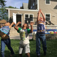 <p>Children play outside Adam J. Lewis Preschool in Bridgeport.</p>