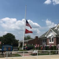 <p>Flags are at half staff in front of the Police Officer Christopher Goodell Public Safety Building in Waldwick.</p>