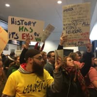 <p>Some of the signs in the crowd at Bradley Airport.</p>
