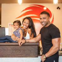 <p>Co-Owners Thara Prashad and Jay Sean with their daughter at their Tenafly studio.</p>