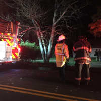<p>Danbury firefighters knock down a two-alarm blaze at 43 Stadley Rough Road on Tuesday evening.</p>