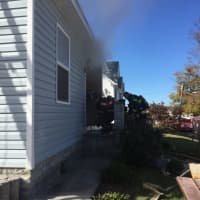 <p>Danbury firefighters responds to a smoky blaze at 23 McDermott St. on Friday afternoon.</p>