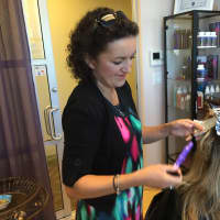 <p>Ela Dalka works with a client at MY SALON Suites Thursday morning.</p>