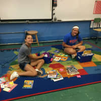 <p>Gracie Burke, left, and friend Allison Ohnegian help third grade Byrd School teacher Jenn Burke set up her Glen Rock classroom.</p>