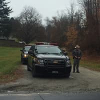 <p>State police patrol the entrance to Windswept Farm, where Lois Colley was killed on Monday.</p>