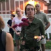 <p>A young woman brought flowers to the vigil.</p>