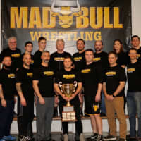 <p>Coaches for the Norwalk Mad Bulls show the championship trophy.</p>